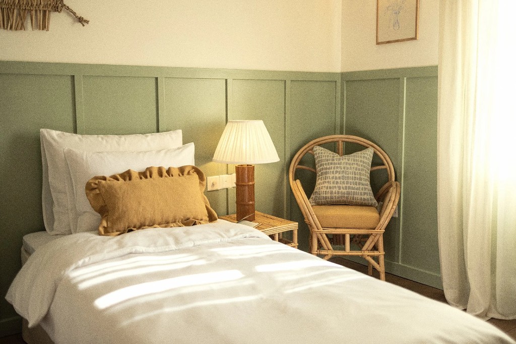Demi Room · a single bed against sage panelling