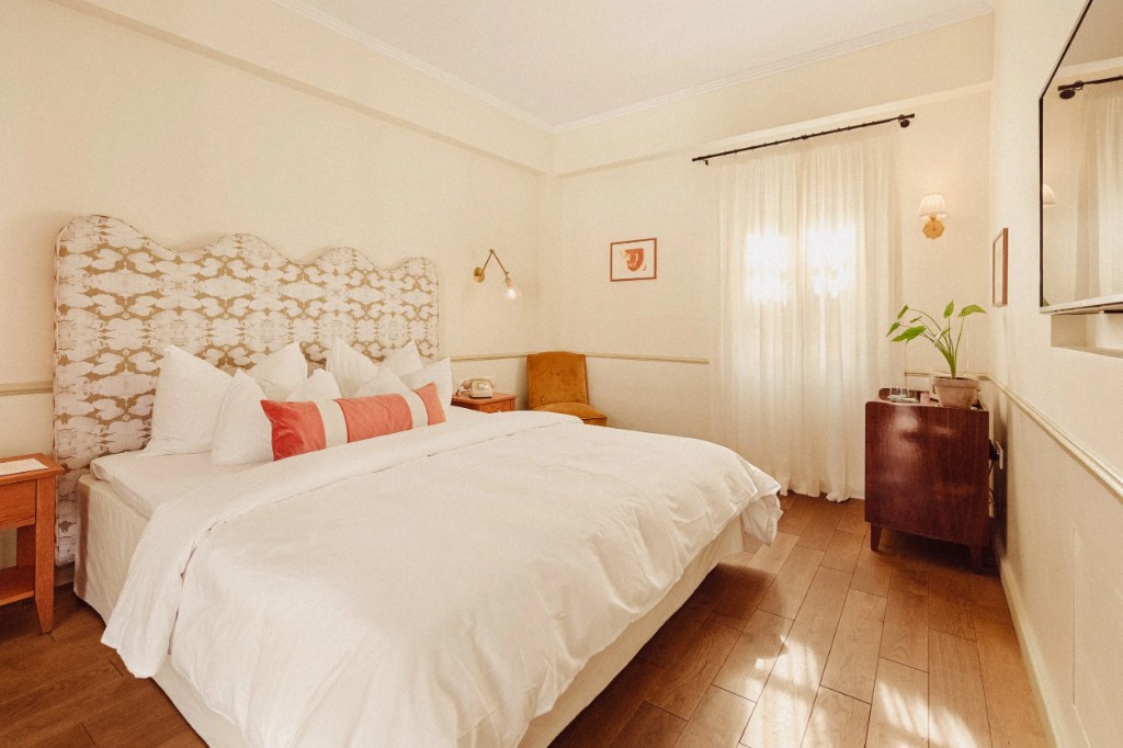 Petite Room · the bedroom with its patterned headboard