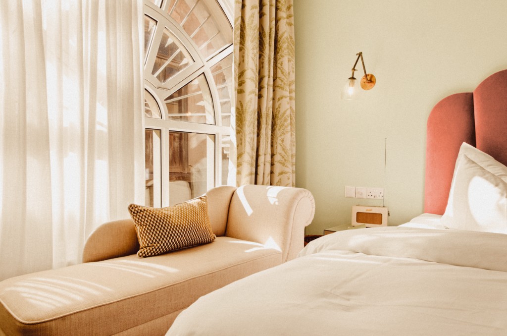 Petite Room · twin layout beneath an arched window